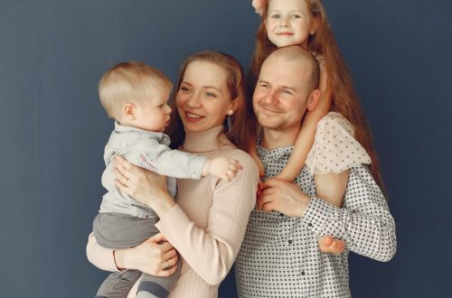A joyful family portrait showcasing parents and their two children, expressing love and togetherness.